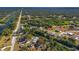 Aerial perspective capturing a community with winding waterways and lush trees under a bright sky at 31 Twig Ct, Port Charlotte, FL 33954