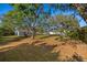 Large backyard with mature trees shading the metal barn at 31 Twig Ct, Port Charlotte, FL 33954