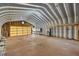 Barn interior features a large roll-up door and plenty of open space for storage or projects at 31 Twig Ct, Port Charlotte, FL 33954