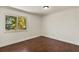 Comfortable bedroom featuring hardwood floors and a large window with scenic views at 31 Twig Ct, Port Charlotte, FL 33954