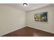 Cozy bedroom with wood floors and a window showcasing a beautiful outdoor view at 31 Twig Ct, Port Charlotte, FL 33954
