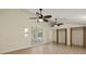 Bonus room with two ceiling fans and closets, offering lots of storage space with direct access to pool at 31 Twig Ct, Port Charlotte, FL 33954