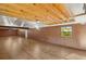 Bright bonus room with wood floors, brick wall, and exposed beam ceiling at 31 Twig Ct, Port Charlotte, FL 33954