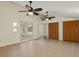Bonus room with tile flooring, ceiling fans, view to the screened pool, and large closets at 31 Twig Ct, Port Charlotte, FL 33954