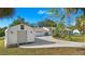 Charming single-story home featuring a separate garage, circular driveway, and a well-maintained lawn at 31 Twig Ct, Port Charlotte, FL 33954