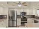 Modern kitchen featuring stainless steel appliances, white cabinetry, and neutral countertops at 31 Twig Ct, Port Charlotte, FL 33954