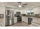 Modern kitchen featuring stainless steel appliances, white cabinetry, and neutral countertops at 31 Twig Ct, Port Charlotte, FL 33954