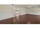 Open concept living room featuring dark hardwood floors, clean white walls and natural light at 31 Twig Ct, Port Charlotte, FL 33954