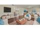 Staged living room featuring dark hardwood floors, clean white walls, natural light, and modern decor at 31 Twig Ct, Port Charlotte, FL 33954