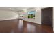 Spacious living room showcasing rich hardwood floors, wainscoting details, and a well-lit, open layout at 31 Twig Ct, Port Charlotte, FL 33954