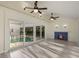 Inviting living room featuring a fireplace and sliding glass doors leading to the pool area at 31 Twig Ct, Port Charlotte, FL 33954