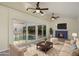 Living room with fireplace, opening to indoor pool, featuring comfortable seating, and stylish decor at 31 Twig Ct, Port Charlotte, FL 33954