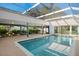 Enclosed in-ground pool with ample seating and lush tropical landscaping at 31 Twig Ct, Port Charlotte, FL 33954