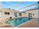 Inviting in-ground pool with screened enclosure and spacious patio area at 31 Twig Ct, Port Charlotte, FL 33954