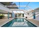 Relaxing in-ground pool with screened enclosure and outdoor living space at 31 Twig Ct, Port Charlotte, FL 33954