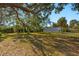 The property features mature trees, lush landscaping, and a metal barn at 31 Twig Ct, Port Charlotte, FL 33954