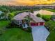 Beautiful aerial view of home with a barrel tile roof, two-car garage, and lake view at 312 148Th Ne Ct, Bradenton, FL 34212