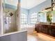 Bright primary bathroom features a walk-in shower, soaking tub, and dual sink vanity with granite countertop at 312 148Th Ne Ct, Bradenton, FL 34212