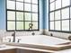 Close up of the primary bathroom tub area with tiled surround and a sculpture on the ledge at 312 148Th Ne Ct, Bradenton, FL 34212