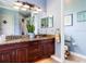 Primary bathroom features dual sink vanity with granite countertop and access to a toilet room at 312 148Th Ne Ct, Bradenton, FL 34212