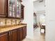 Butlers pantry with wine rack and storage at 312 148Th Ne Ct, Bradenton, FL 34212