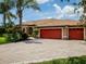 Charming home with a three-car garage, lovely landscaping, and a spacious driveway at 312 148Th Ne Ct, Bradenton, FL 34212