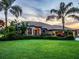 Well-maintained home showcasing lush green lawn and tropical landscaping at 312 148Th Ne Ct, Bradenton, FL 34212