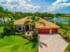 Beautiful single-Gathering home with a barrel tile roof, palm trees, paver driveway, and a two-car garage at 312 148Th Ne Ct, Bradenton, FL 34212