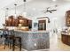 Spacious kitchen featuring an island with barstool seating, granite countertops, and stainless steel appliances at 312 148Th Ne Ct, Bradenton, FL 34212