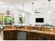 Open kitchen featuring pendant lighting, granite countertops, dark wood cabinets, and stainless steel appliances at 312 148Th Ne Ct, Bradenton, FL 34212