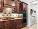 Dark wood kitchen with gas cooktop and double oven at 312 148Th Ne Ct, Bradenton, FL 34212