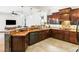 Modern kitchen with wood cabinets, granite countertops, stainless steel appliances, and an open layout at 312 148Th Ne Ct, Bradenton, FL 34212
