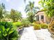 Lush landscaping frames this home, showcasing a stone walkway and verdant tropical plants at 312 148Th Ne Ct, Bradenton, FL 34212