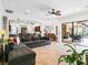 Open-concept living room boasts a large sectional couch and seamless flow to the outdoor patio at 312 148Th Ne Ct, Bradenton, FL 34212