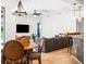 Cozy living area with a round dining table, decorative chandelier, large-screen TV, and comfortable seating at 312 148Th Ne Ct, Bradenton, FL 34212