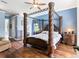 Spacious main bedroom featuring four-poster bed, fireplace, and hardwood floors at 312 148Th Ne Ct, Bradenton, FL 34212