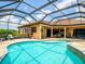 Spacious screened-in pool and hot tub area with outdoor seating and dining spaces for relaxing and entertaining at 312 148Th Ne Ct, Bradenton, FL 34212