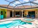 Aerial view of the screened in pool and hot tub with a covered patio for dining and lounging at 312 148Th Ne Ct, Bradenton, FL 34212