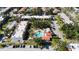 Community aerial view showcasing building layout, a central pool, parking, and lush landscaping at 3253 Beneva Rd # 103, Sarasota, FL 34232
