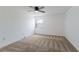 Bright bedroom with neutral carpet, ceiling fan, and a window providing natural light at 3253 Beneva Rd # 103, Sarasota, FL 34232