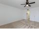 Bright bedroom with neutral carpet, ceiling fan, and doorway visible to a closet at 3253 Beneva Rd # 103, Sarasota, FL 34232