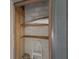 Small, unfinished closet with wooden shelving and concrete block walls at 3253 Beneva Rd # 103, Sarasota, FL 34232