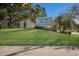 Exterior shot of the Village Brooke condominiums sign, set against a manicured lawn and bright blue sky at 3253 Beneva Rd # 103, Sarasota, FL 34232