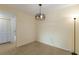 Open dining area with tile floors, neutral walls, decorative light fixture, and closet doors at 3253 Beneva Rd # 103, Sarasota, FL 34232
