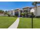 Inviting condo building with manicured lawn and charming walkway leading to the entrance at 3253 Beneva Rd # 103, Sarasota, FL 34232