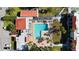 Aerial view of a pristine community pool, surrounded by lounge chairs, palm trees, and well-maintained landscaping at 3253 Beneva Rd # 103, Sarasota, FL 34232