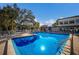 Sparkling community pool with blue water and inviting lounge area with ample seating at 3253 Beneva Rd # 103, Sarasota, FL 34232