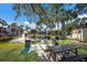 Pondside recreation area with a grill and picnic table, perfect for outdoor gatherings and relaxation at 3253 Beneva Rd # 103, Sarasota, FL 34232