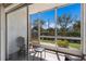 Enclosed sunroom features outdoor views and seating, perfect for relaxation at 3253 Beneva Rd # 103, Sarasota, FL 34232