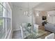 Bright dining area with glass table, white chairs, and large window at 3702 54Th W Dr # 102, Bradenton, FL 34210